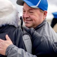 President Mantella hugs a guest at the tailgate
